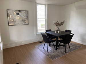 Dining space with baseboards and wood finished floors