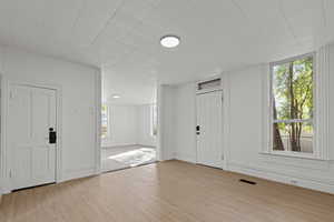 Entrance foyer featuring light wood-type flooring and baseboards