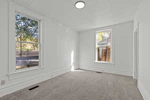 Unfurnished room with carpet floors