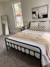 Carpeted bedroom featuring baseboards
