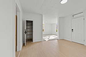 Foyer featuring light wood-type flooring and baseboards