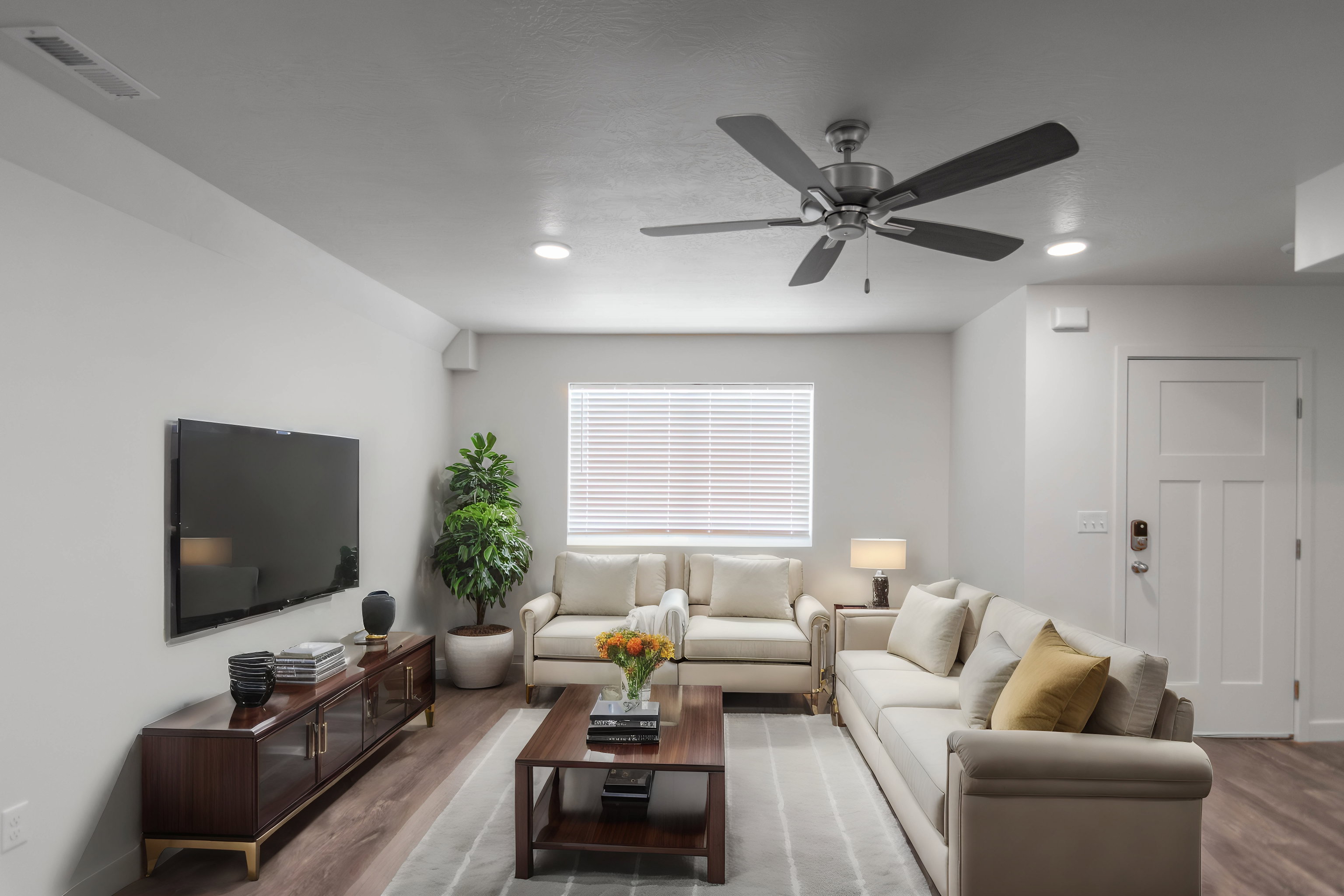 Living room with wood finished floors and a ceiling fan