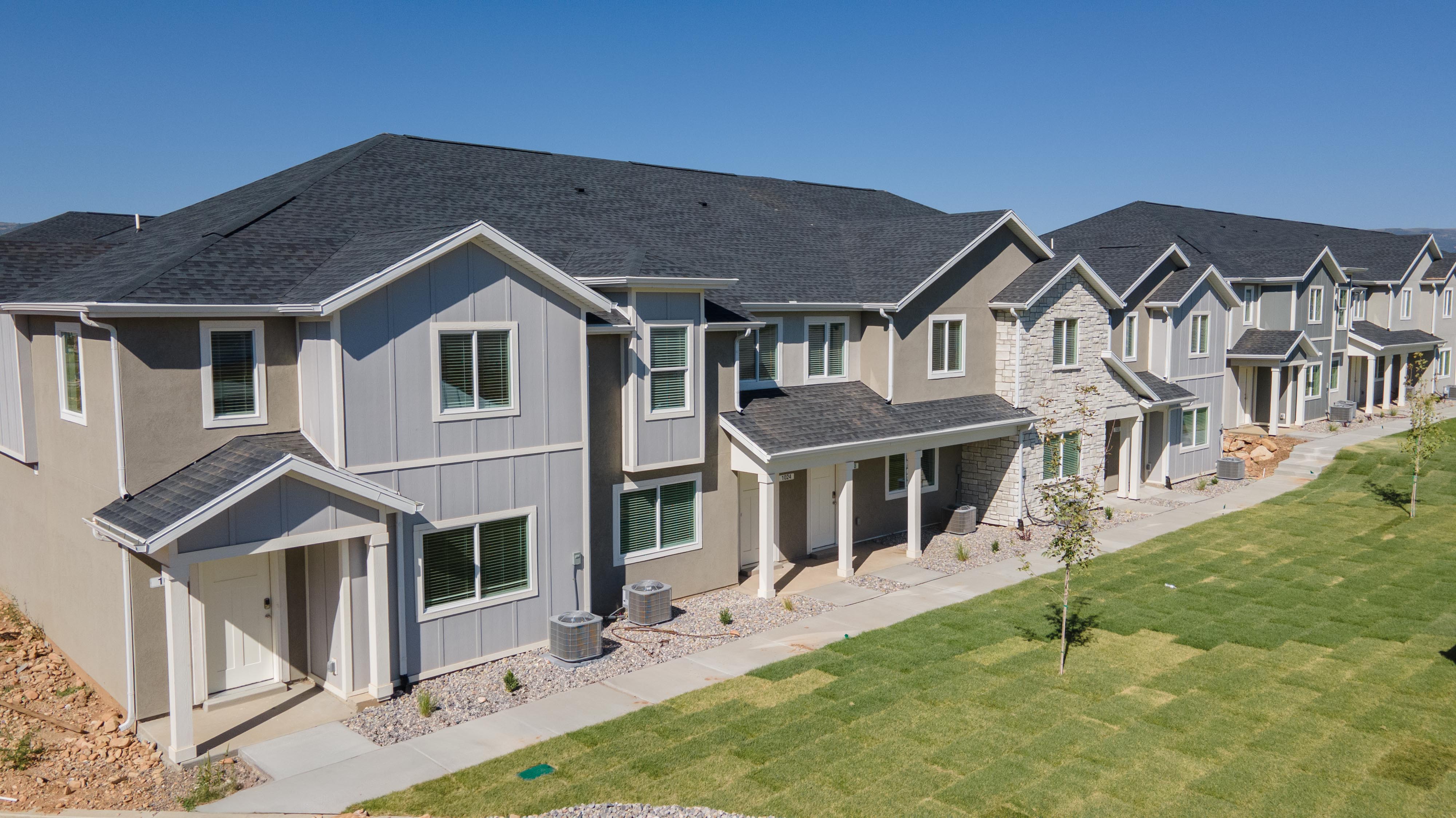 View of front of home featuring board and batten siding, a shingled roof, a front lawn, a residential view, and a porch