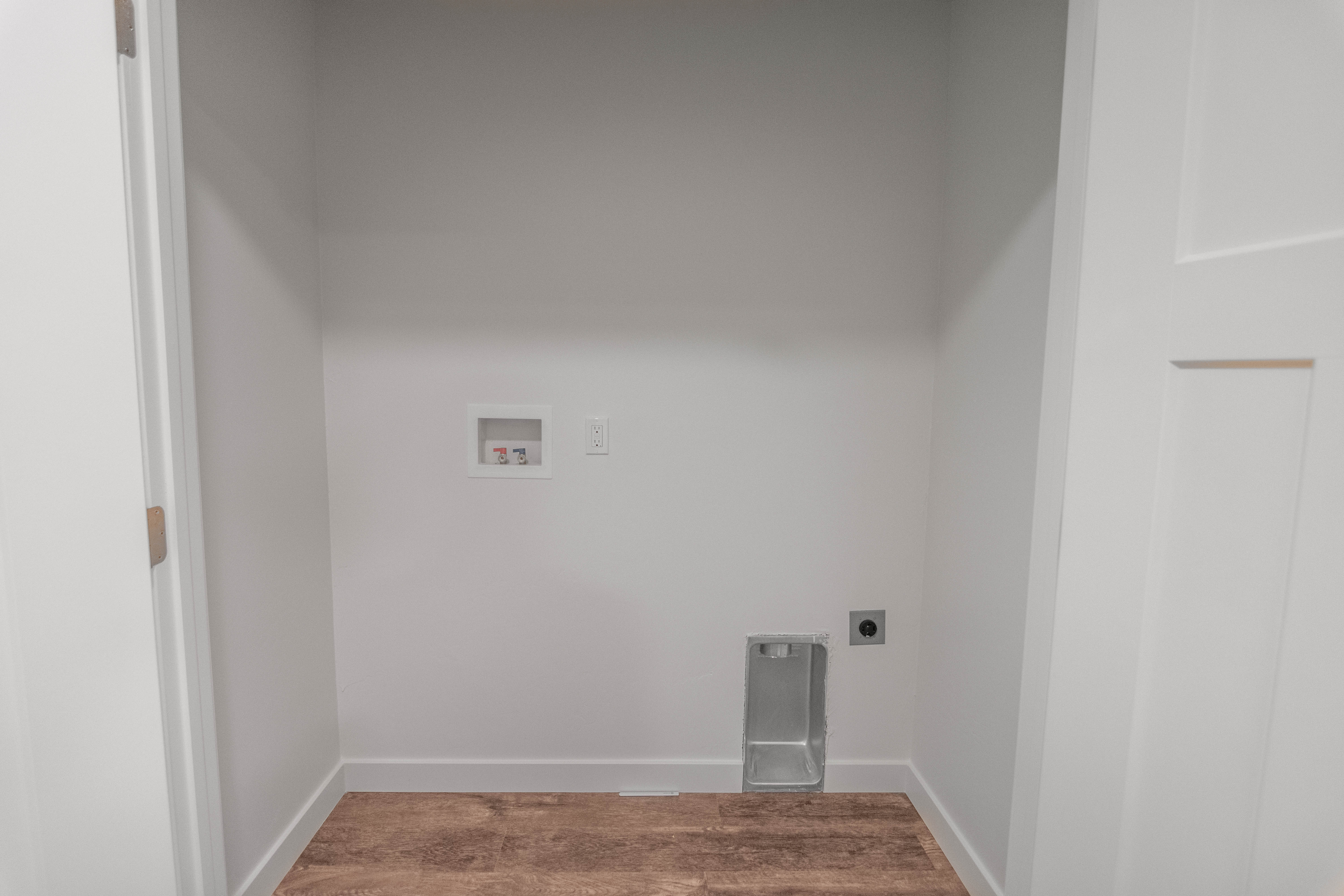 Laundry room featuring washer hookup, wood finished floors, and electric dryer hookup