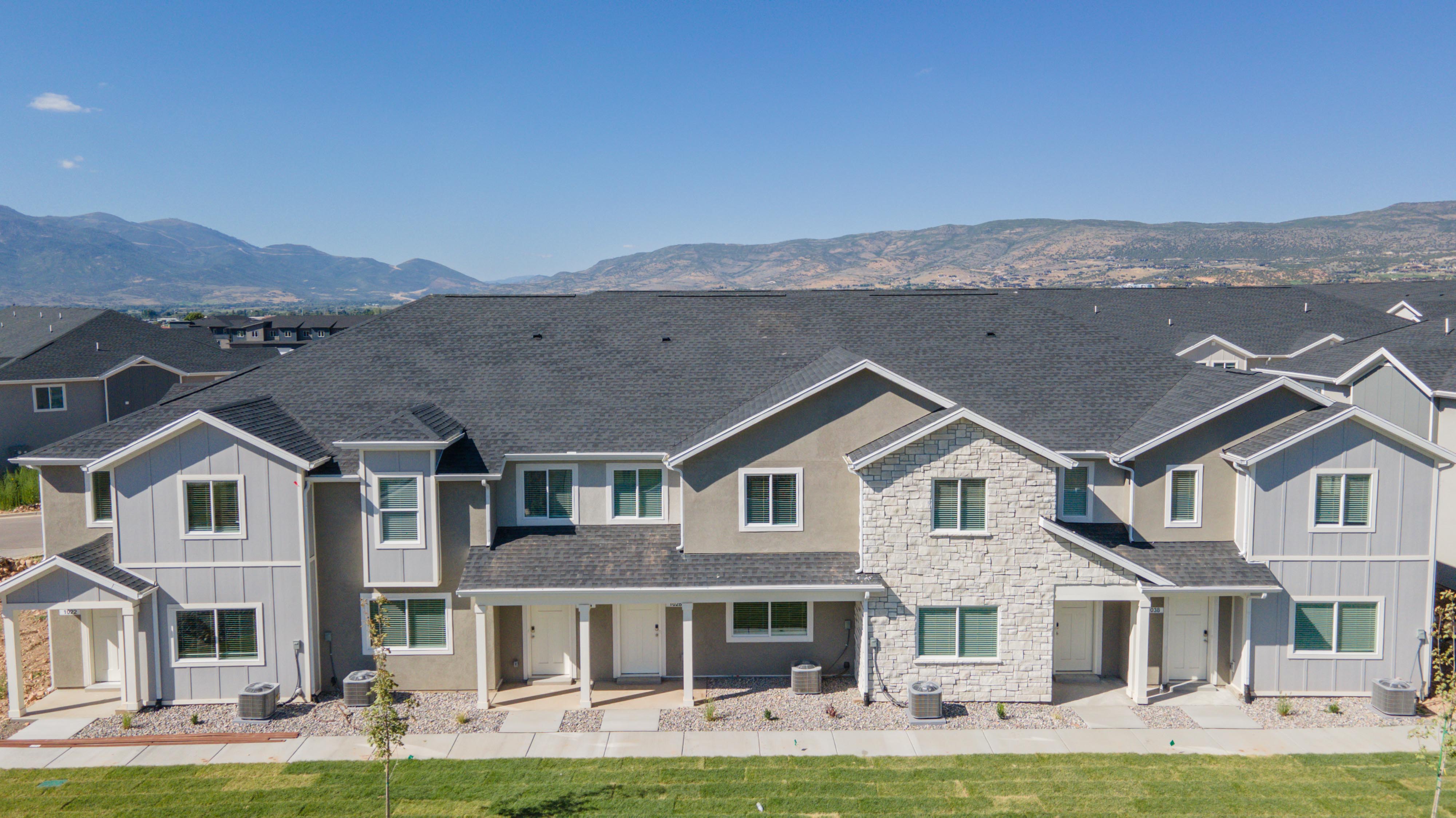 View of front facade with board and batten siding, a mountain view, and a porch