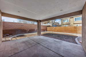 Fenced backyard with a patio