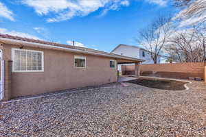 Back of house featuring a patio area, a fenced backyard, and stucco siding