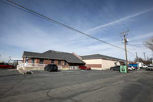 View of building exterior featuring uncovered parking