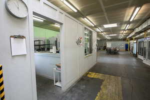 Corridor featuring concrete flooring