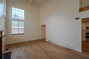 Unfurnished living room with light wood finished floors and a ceiling fan