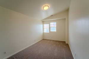 Empty room featuring carpet floors and baseboards