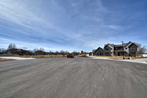 View of asphalt road with a residential view and curbs