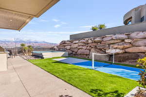Fenced backyard featuring a mountain view and a patio