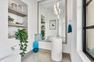 Bathroom with toilet and built in shelves