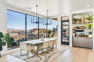 Dining room featuring light wood-style flooring and suspended lighting