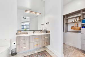 Bathroom featuring vanity and a spacious closet