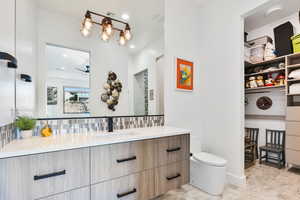 Bathroom with vanity and backsplash