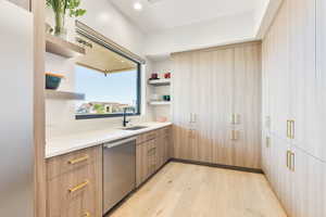 Kitchen featuring light wood finished floors, open shelves, dishwasher, modern cabinets, and recessed lighting