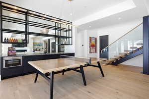 Custom Ping / Pong and Wet Bar with ice maker, dishwasher, microwave, beverage fridges, and wine fridge