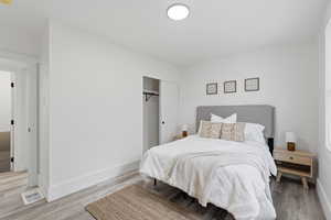 Bedroom with a closet and light wood finished floors