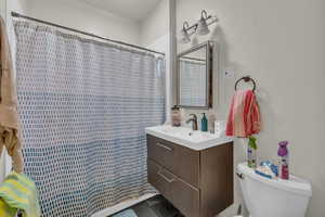Bathroom featuring vanity and curtained shower
