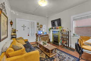 Living area featuring wood finished floors and a fireplace with flush hearth