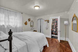 Bedroom featuring wood finished floors and baseboards
