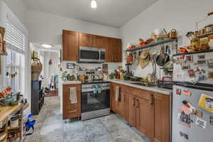 Kitchen with wood finish cabinetry and stainless steel appliances