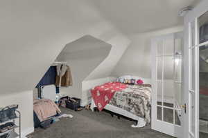 Carpeted bedroom with vaulted ceiling