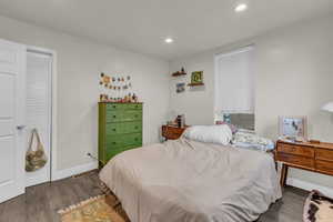 Bedroom featuring dark wood-style floors and recessed lighting