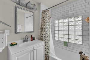 Full bathroom with vanity and shower / bathtub combination with curtain