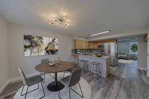 Dining room with dark wood finished floors and baseboards
