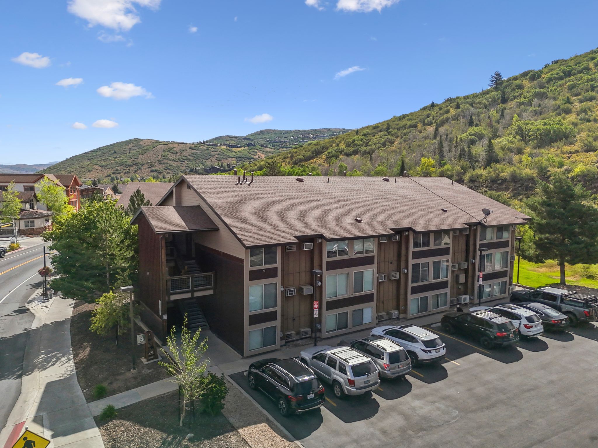 View of building exterior with uncovered parking and a mountain view