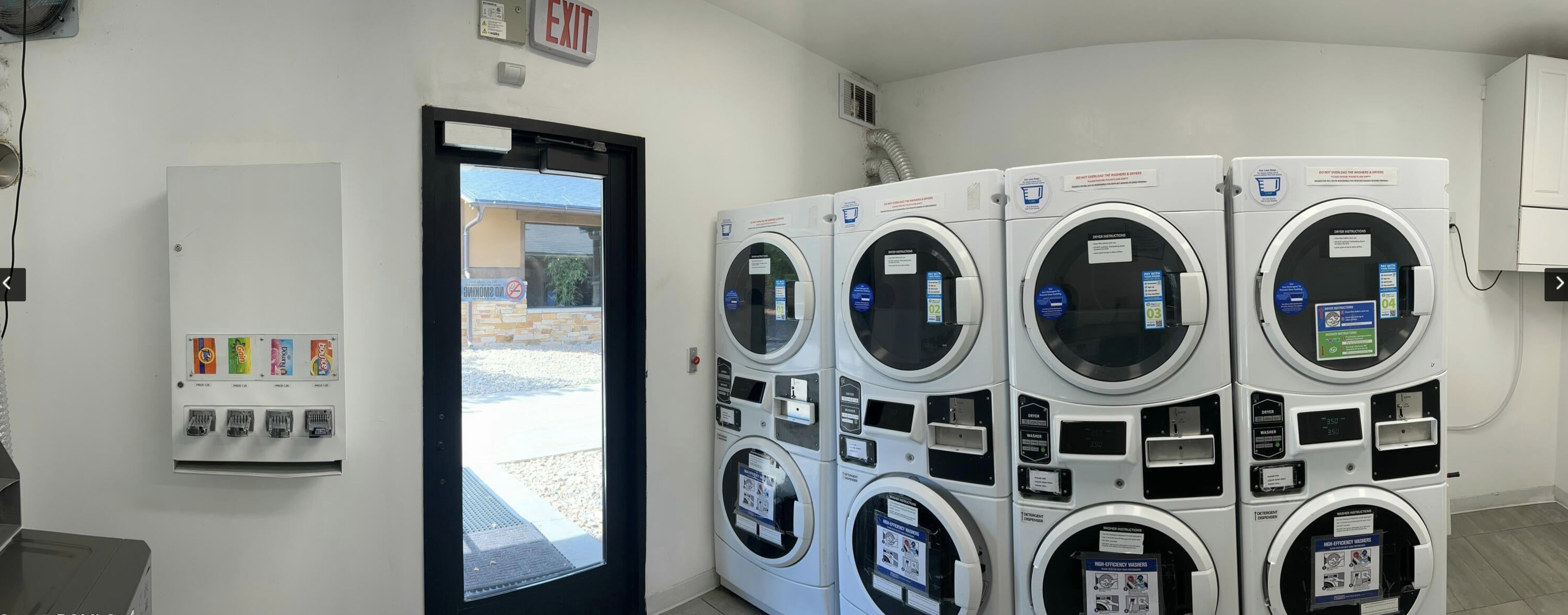 Shared laundry room with stacked washing machine and dryer