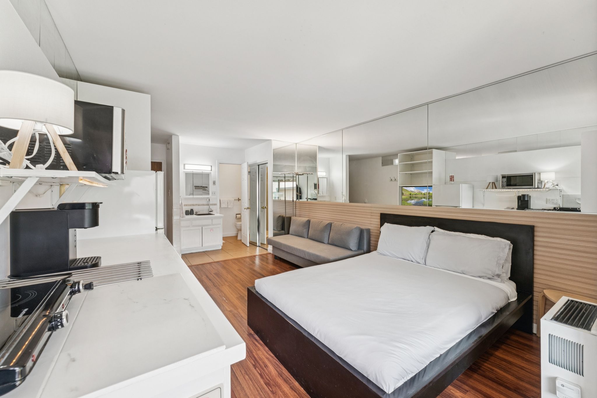 Bedroom featuring light wood-type flooring and ensuite bathroom