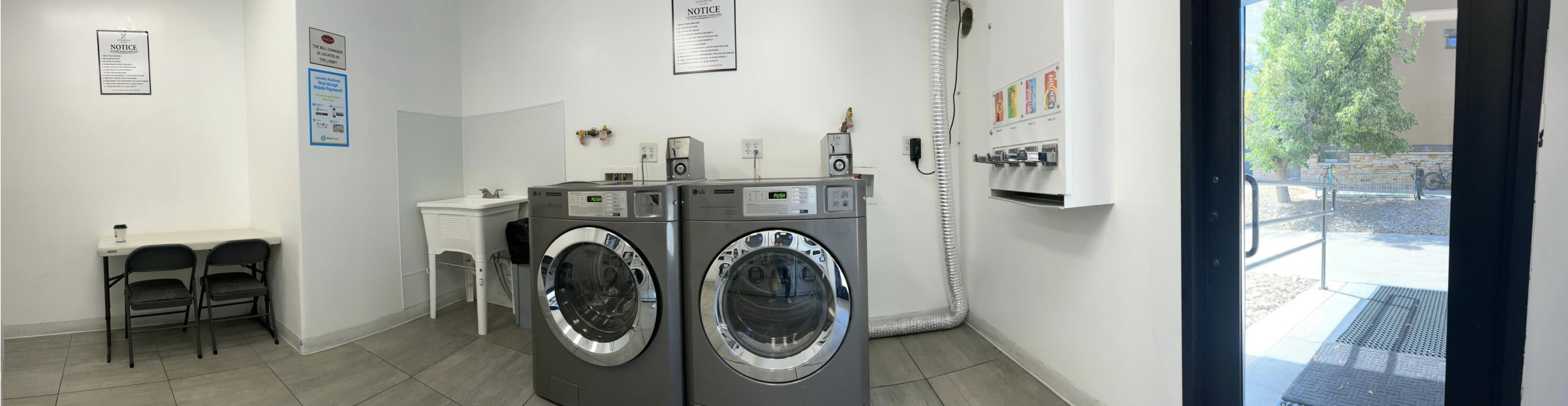 Shared laundry featuring washing machine and clothes dryer