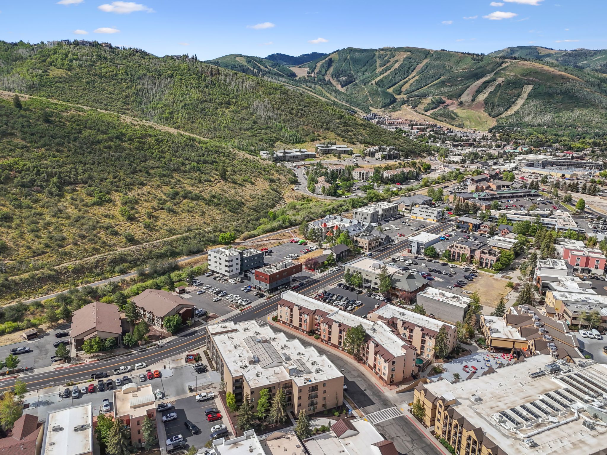 Aerial view of property and surrounding area featuring a mountainous background