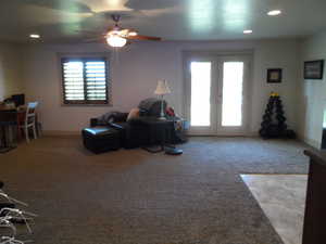 Living room with light carpet, recessed lighting, french doors, and a ceiling fan