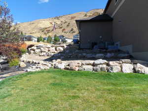 View of green lawn featuring a mountain view