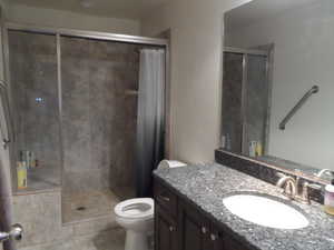 Full bathroom with a stall shower and vanity