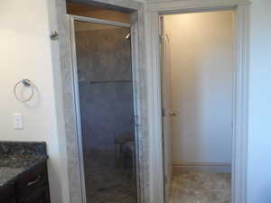 Bathroom with vanity and a stall shower