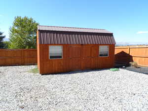 View of shed featuring a fenced backyard