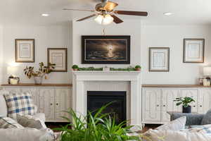 Living room featuring a fireplace, recessed lighting, and a ceiling fan