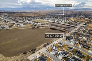 Aerial overview of property's location featuring nearby suburban area and mountains