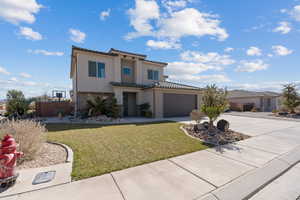 Mediterranean / spanish house featuring an attached garage, driveway, stucco siding, and a tile roof