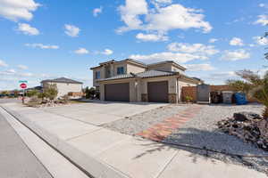 Mediterranean / spanish-style house with a gate, concrete driveway, stucco siding, a tile roof, and stone siding