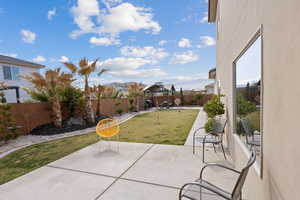 Fenced backyard featuring a patio area and a gazebo