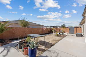 Fenced backyard featuring a patio and a gate