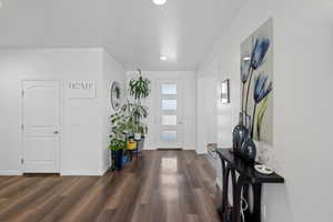 Foyer entrance with dark wood-type flooring and recessed lighting