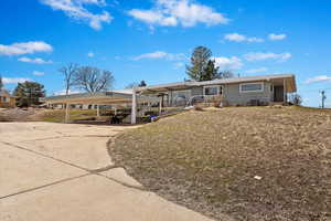 Ranch-style house with driveway and a carport
